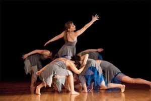 several female students performing a dance on stage