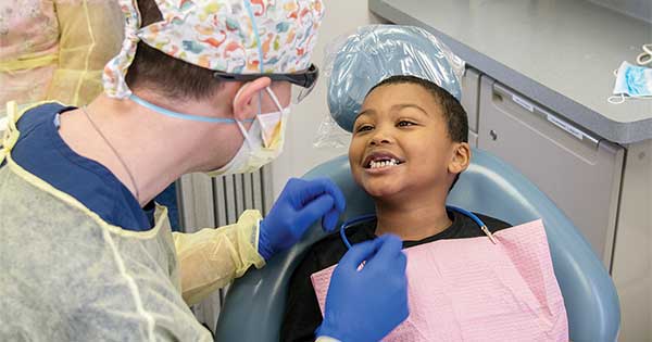dentist working on small child in chair