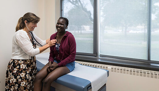 A female nurse checking a patients heartbeat