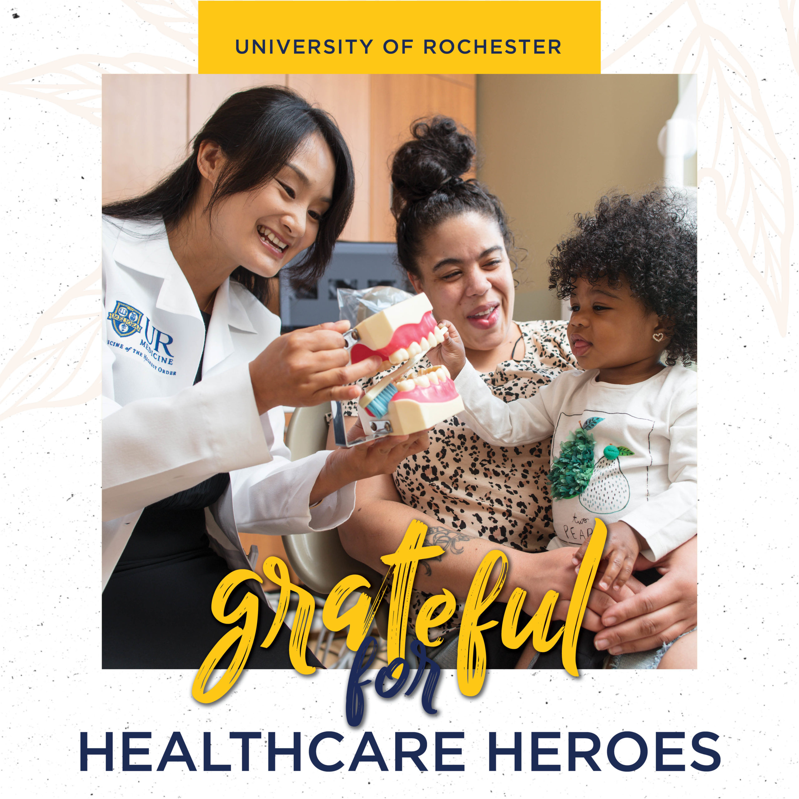 grateful for healthcare heroes - doctor with mother and child holding model of teeth