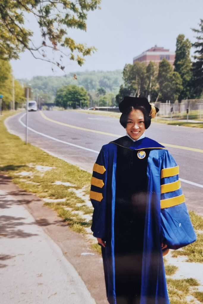 Joanne Y. Law at the University’s 1998 Commencement ceremony in her cap and gown