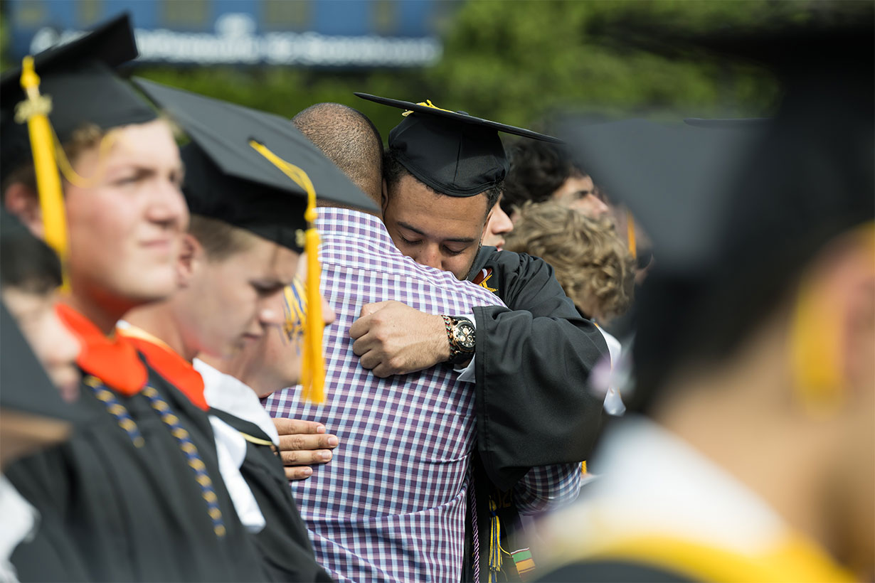 graduate hugging someone during graduation