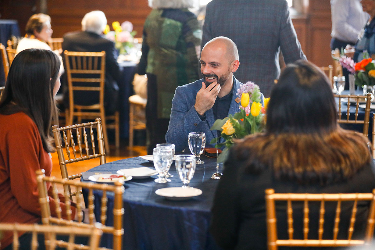 a man and two woman at a table during reception