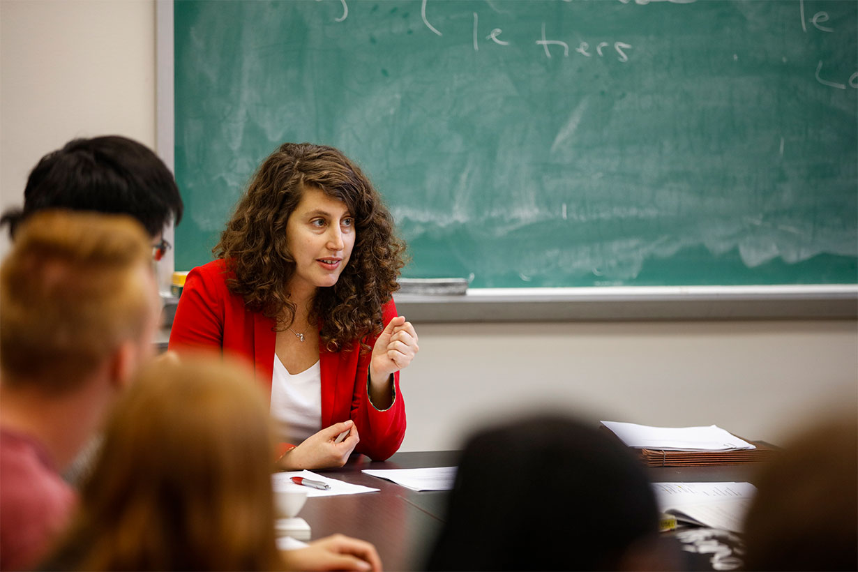woman teaching in front of chalk board
