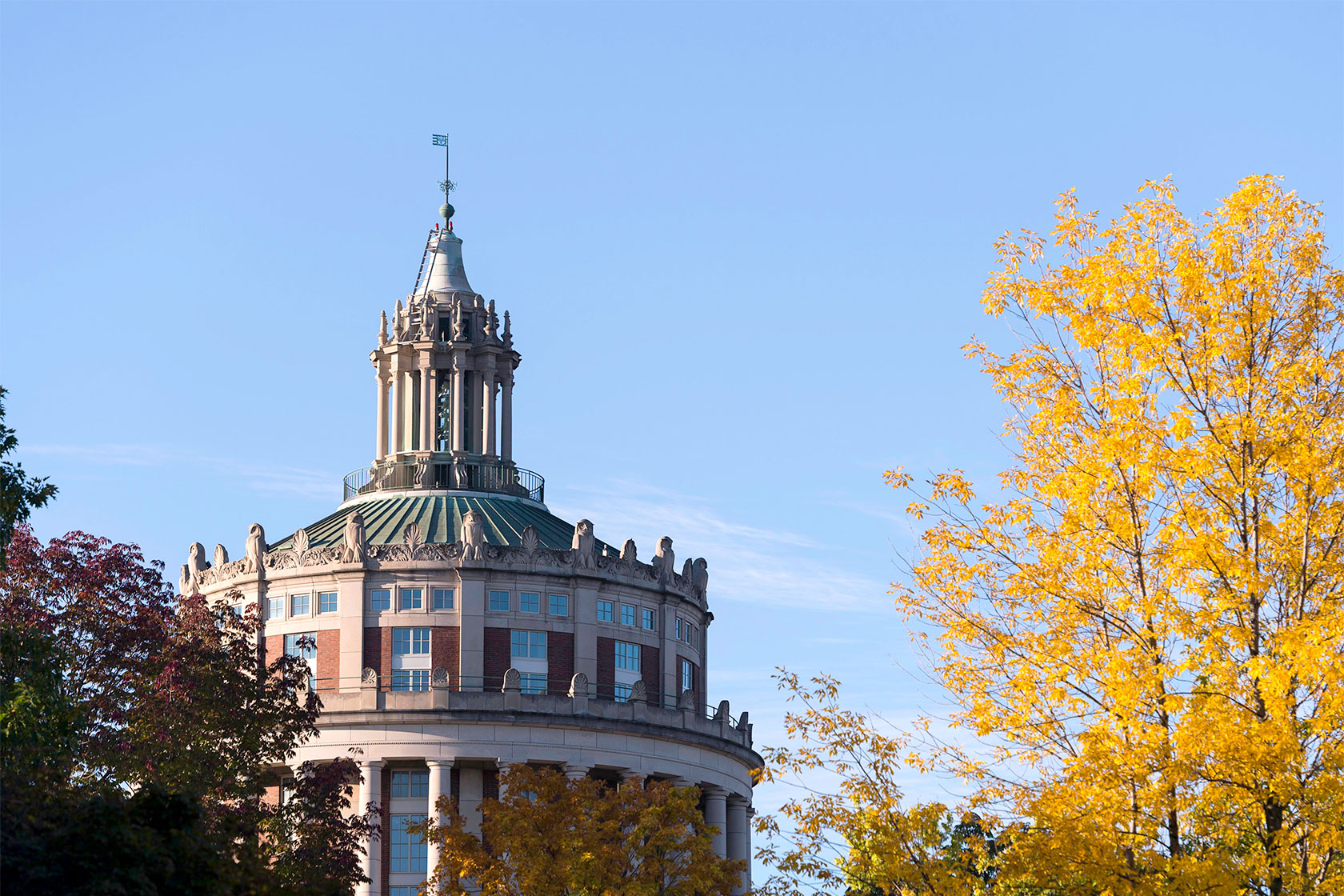 Rush Rhees library with autumn trees on foreground