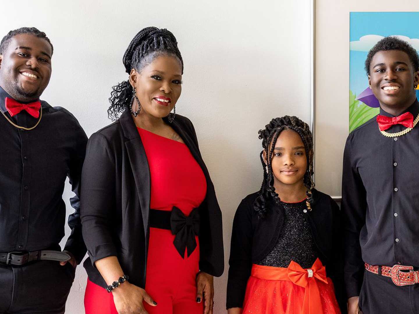 The Jackson family poses, wearing black and red