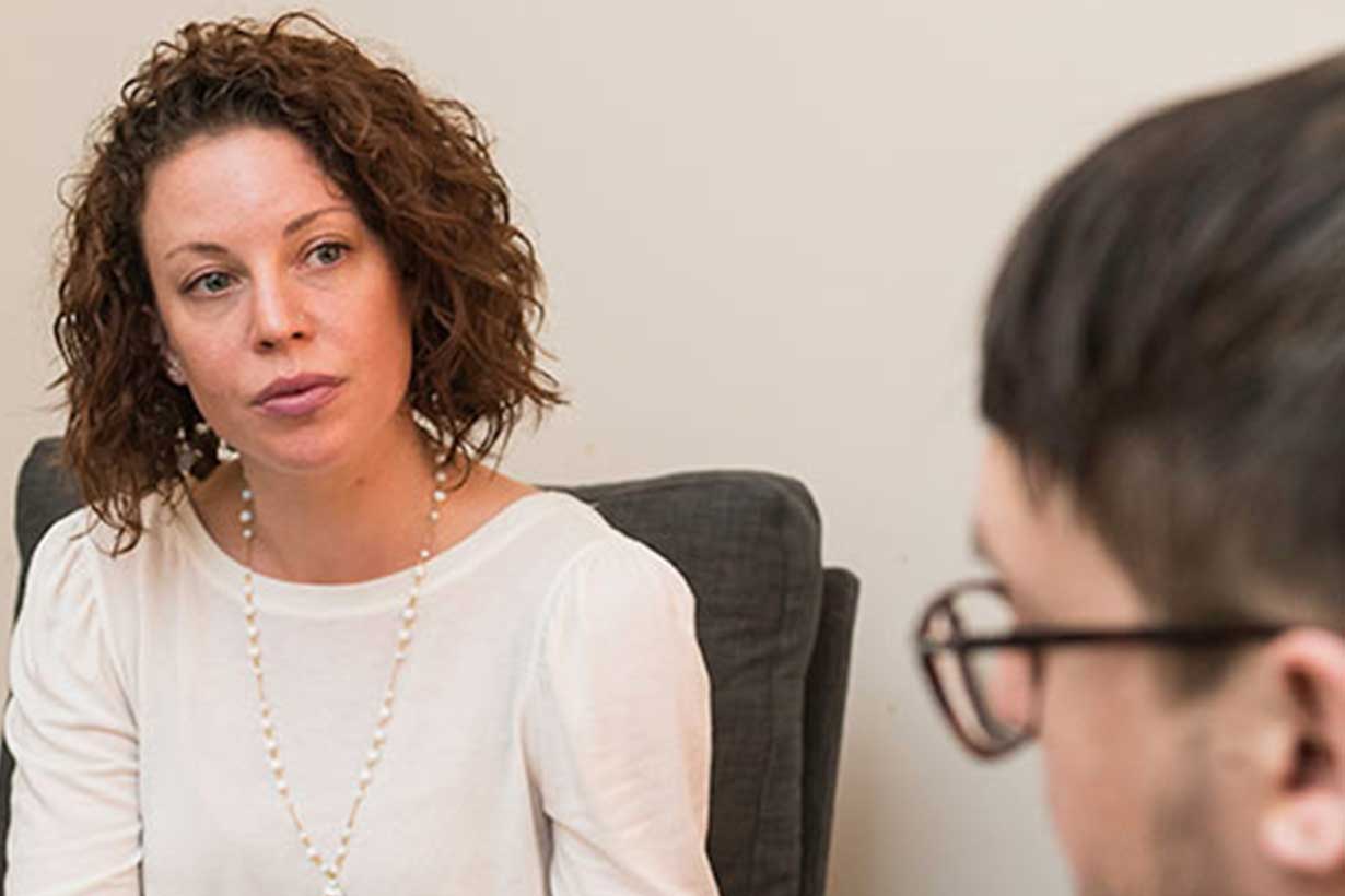 a woman and man looking at each other having a conversation