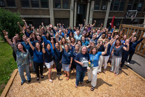 large group of volunteers posing for photo