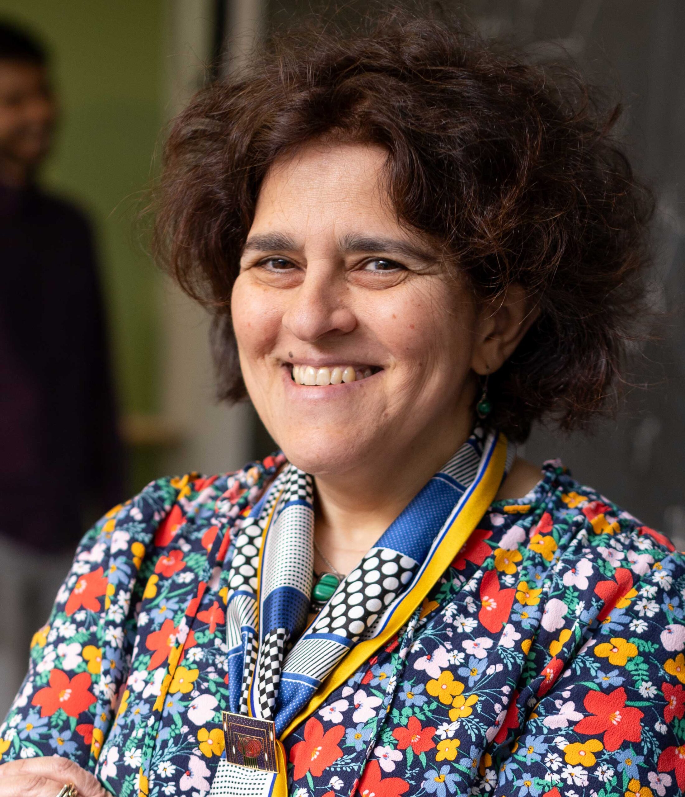 Maria “Masha” Gordina seen smiling, wearing a colorful floral shirt