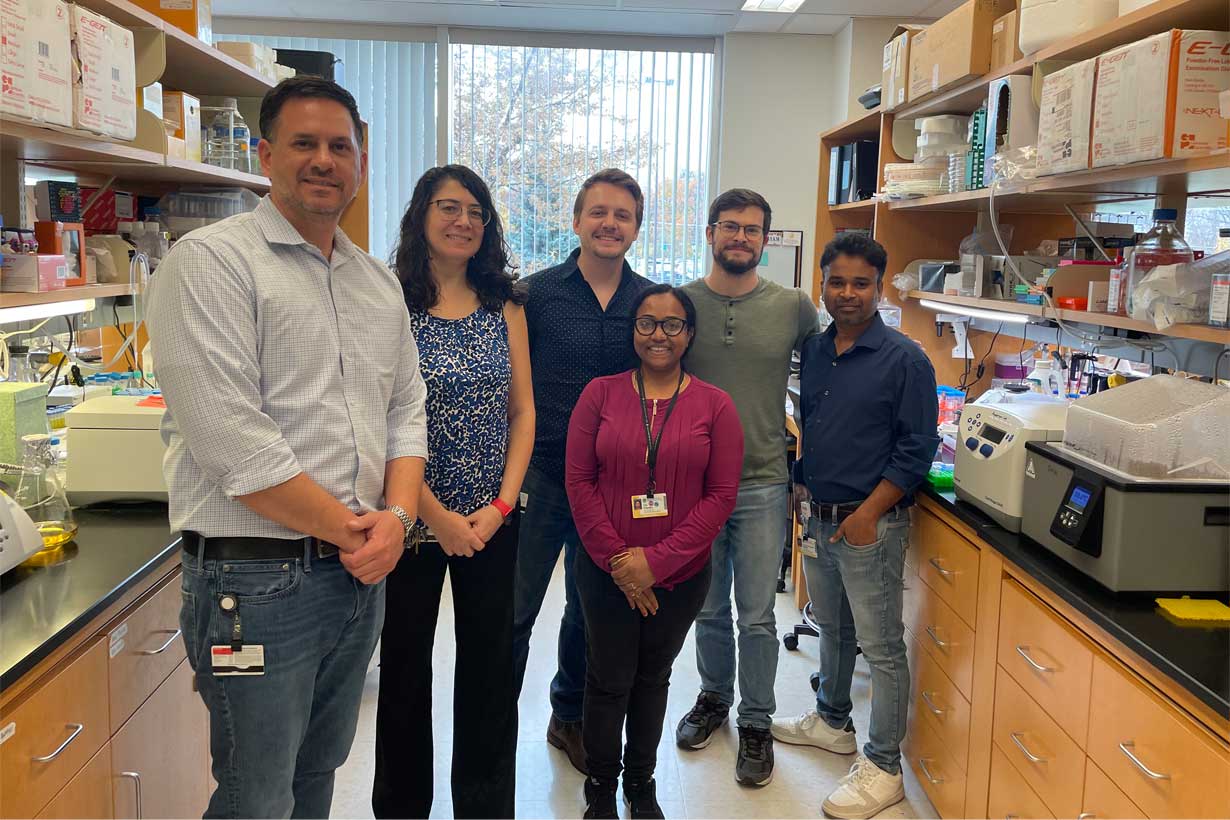 Douglas Anderson stands in a lab with 5 other members of his team