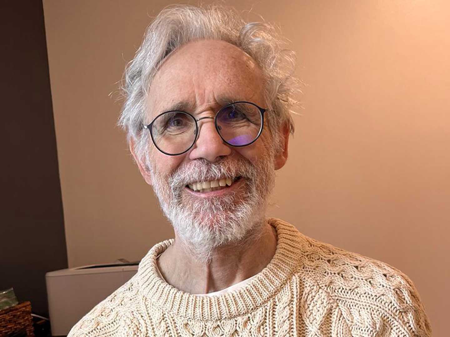 David Hursch seen smiling, wearing white sweater