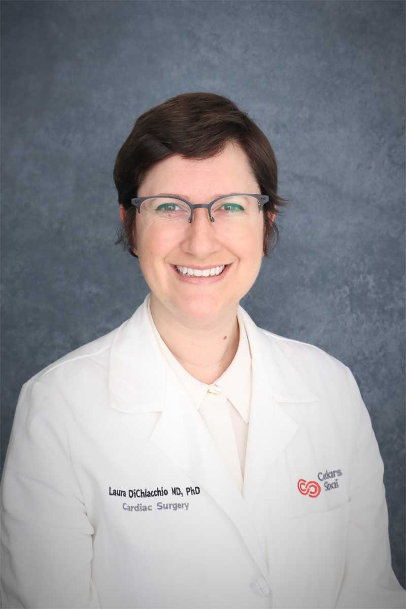 Laura DiChiacchio headshot, seen wearing glasses and a white lab coat
