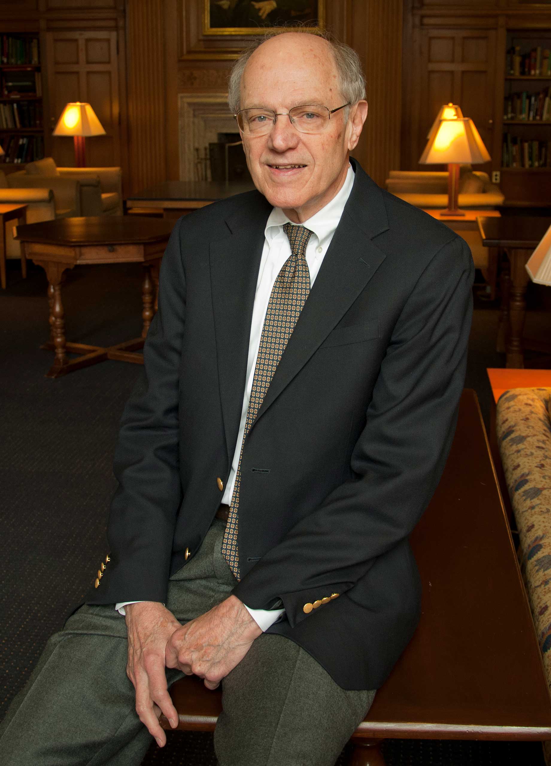 Joseph Eberly seen sitting, smiling, wearing a suit