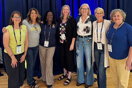 Meliora Weekend 2025's 50th anniversary celebration of women's volleyball. Left to right: Martha Priedeman Skiles ’86, Pauline Lucero ’85, Romy Toussaint ’85, Karen Pavlicin ’87, Gretchen Lowe '84, Kim Kimbrough ’84, and Jenny Swift '84. 