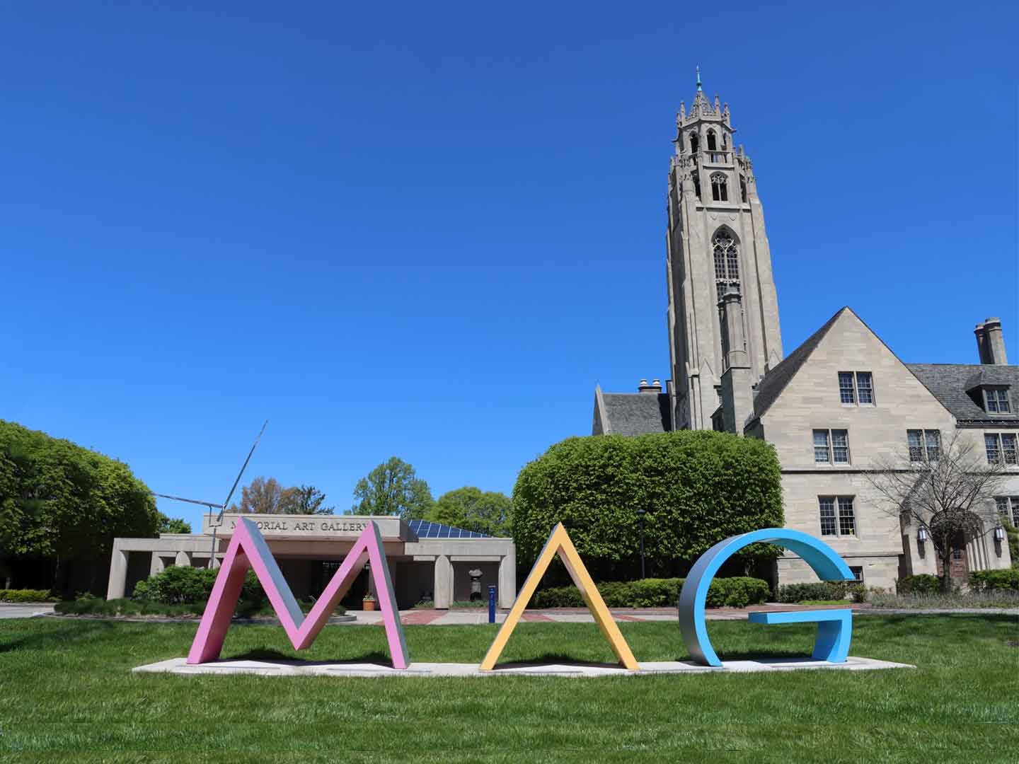 Exterior of Memorial Art Gallery building with MAG letters in front on the lawn