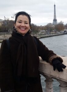 Kimberly Santiago standing on a bridge in Paris