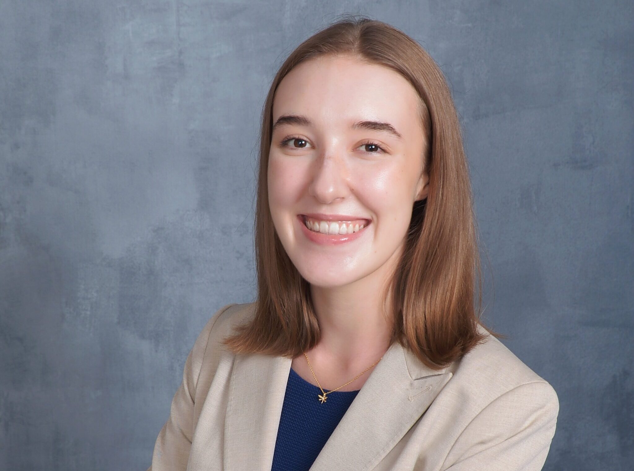 Victoria Hirst ’24 standing in front of a grey background