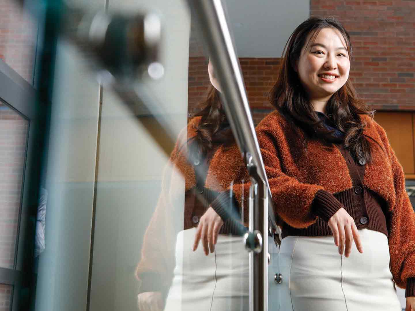 Yuchen Lu leaning against a bannister