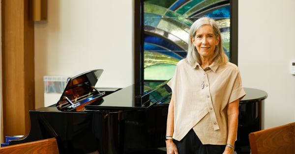 Janice Willett standing in front of a desk