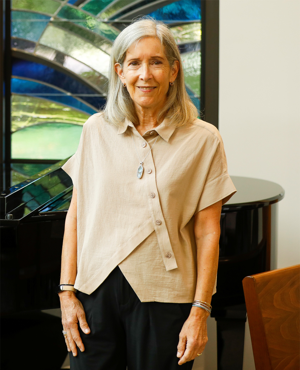 Janice Willett standing in front of a desk